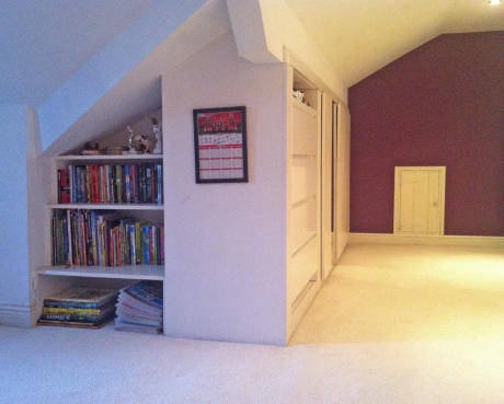 Staggered bookshelves in roof space