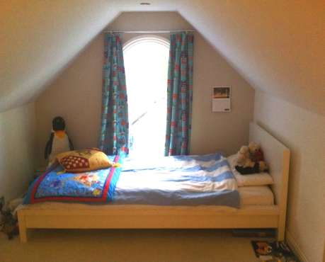 Cosy bed space. White Malm single bed from Ikea