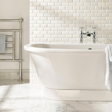 Delicately veined marble brick tiles give a translucent glow to this bathroom/ Original Style