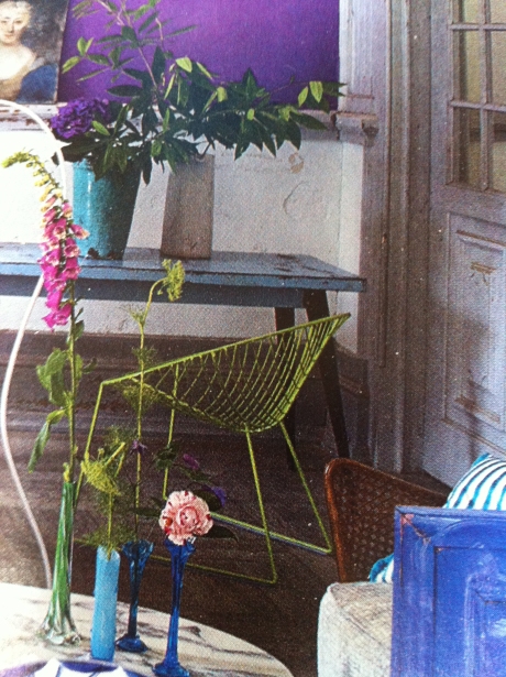 Like a delicate plant, lime-coloured wire chair amongst the flowers